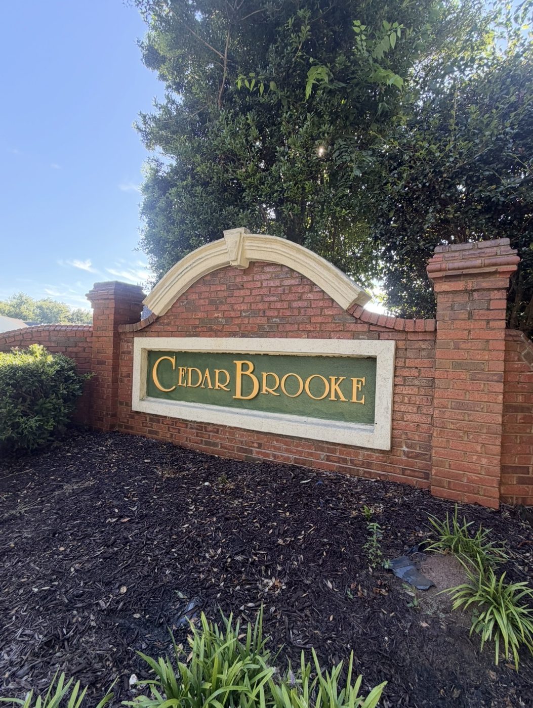 Cedar Brooke neighborhood entrance sign after soft wash, clean white arch and frame, Greenwood SC