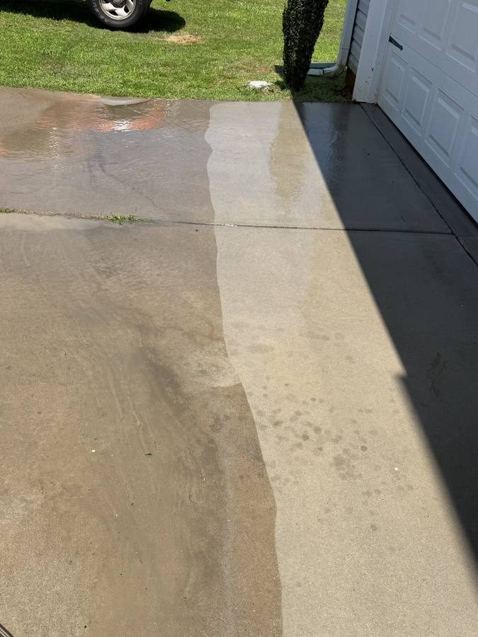 Concrete driveway mid-clean showing clean and dirty sections, Greenwood SC