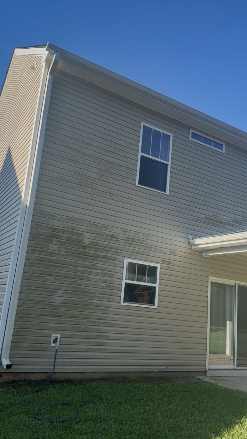 Two-story house before soft wash, green algae on vinyl siding, Greenwood SC